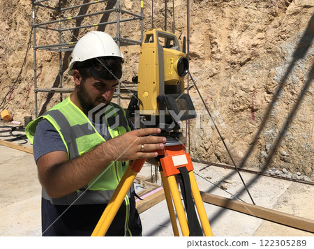 Land surveyor works at construction site Land surveyor works at construction site 122305289