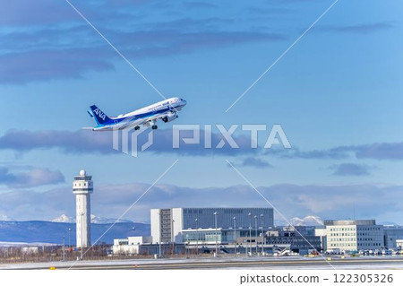 New Chitose Airport in winter, airplane taking off, Chitose, Hokkaido 122305326
