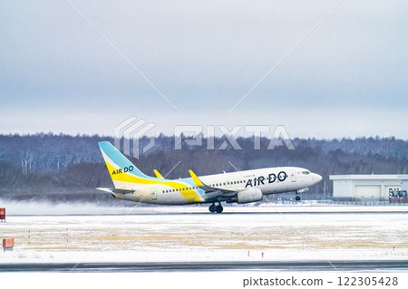 New Chitose Airport in winter: Snow smoke and planes taking off, Chitose, Hokkaido 122305428
