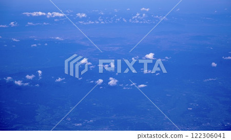 Mountains seen between sea of clouds seen from an airplane Mountains seen between sea of clouds seen from an airplane 122306041