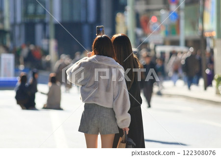 Two women walking through Ginza's pedestrian zone 122308076