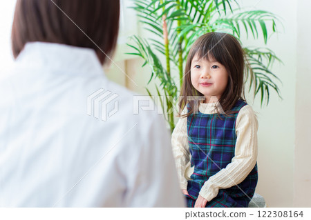 Girl receiving medical treatment at hospital Girl receiving medical treatment at hospital 122308164