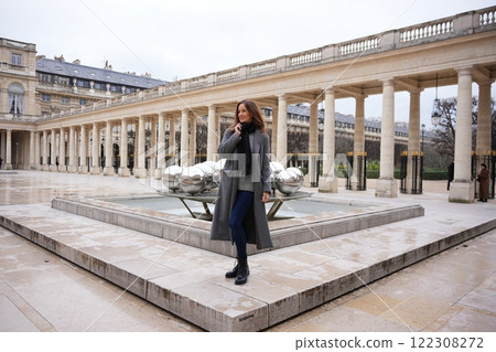 Stylish Woman Exploring Palais Royal Courtyard in Paris Stylish Woman Exploring Palais Royal Courtyard in Paris 122308272