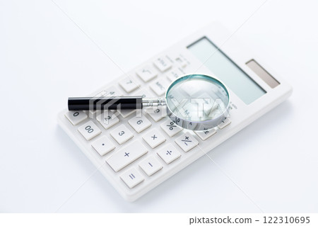 White calculator and magnifying glass White calculator and magnifying glass 122310695
