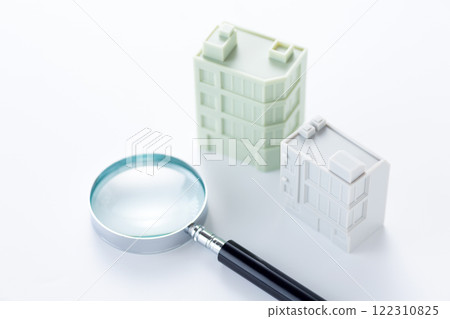 Magnifying glass and company office building Magnifying glass and company office building 122310825