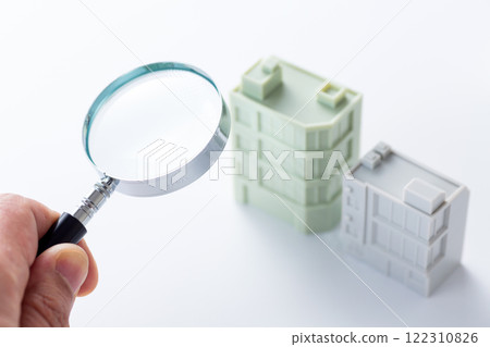 Magnifying glass and company office building 122310826