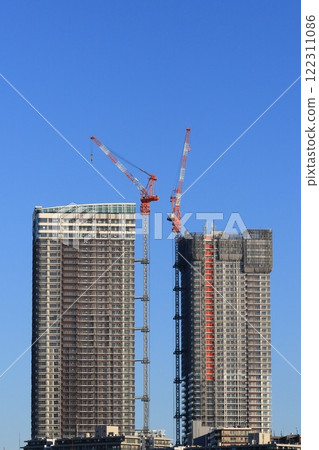 High-rise apartment building construction site: Tower crane installed on a high-rise building under construction 122311086