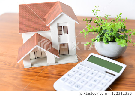 Real estate image of a house model and a calculator Real estate image of a house model and a calculator 122311356