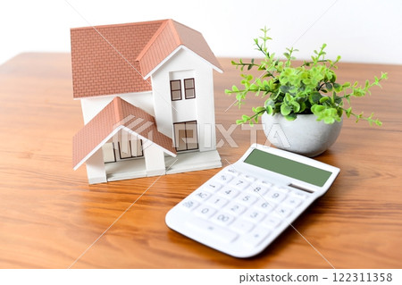 Real estate image of a house model and a calculator Real estate image of a house model and a calculator 122311358