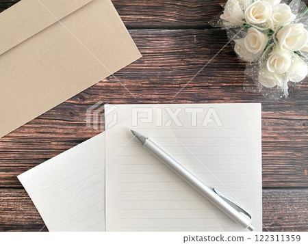 Letter set and pen on a wooden table 122311359
