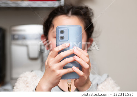 A girl watching a smartphone 122311585