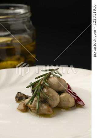 Oysters marinated in oil served on a plate Oysters marinated in oil served on a plate 122311916