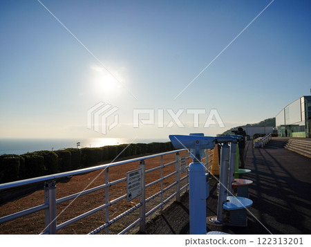 An observation deck overlooking the sea, bathed in the morning sun 122313201