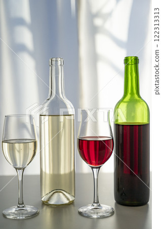 Red and white wine poured into glasses 122313313