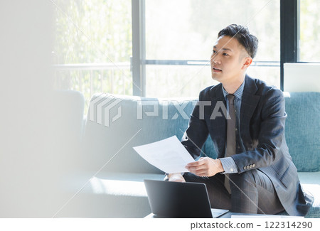 Salesman negotiating with documents in hand 122314290