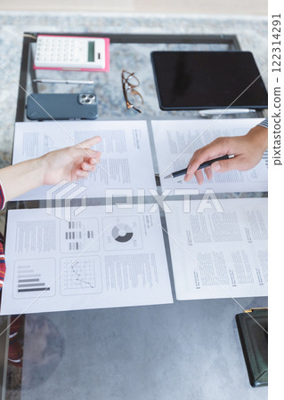 The hand of a businessman pointing to the document 122314291