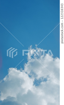 Blue Sky With Beautiful Natural White Clouds. Panorama Blue Sky With Cloud And Sunshine Background. Vertical Time Lapse. Blue Sky With Beautiful Natural White Clouds. Panorama Blue Sky With Cloud And Sunshine Background. Vertical Time Lapse. 122316343