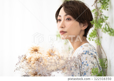 Beauty image (middle-aged woman with short hair holding dried flowers) Beauty image (middle-aged woman with short hair holding dried flowers) 122316350