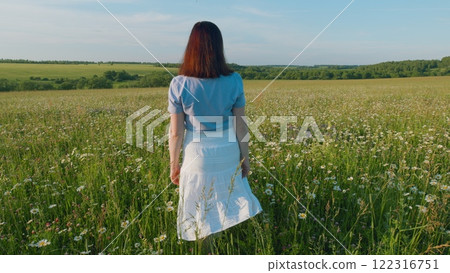 Holidays Weekend Adventure. Portrait - Countryside Woman Hold Flowers In Rural Nature. Magical Landscape With Wildflower Field, Travel And Spring Concept. Steadicam Shot. Holidays Weekend Adventure. Portrait - Countryside Woman Hold Flowers In Rural Nature. Magical Landscape With Wildflower Field, Travel And Spring Concept. Steadicam Shot. 122316751