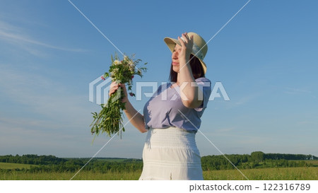 Privacy With Nature. Female With Fresh Blossom Bouquet Flowers In Sunlight At Sunset. Lady Face With Fresh Spring Chamomiles Bouquet At Blue Sky Background. Moves slowly. Privacy With Nature. Female With Fresh Blossom Bouquet Flowers In Sunlight At Sunset. Lady Face With Fresh Spring Chamomiles Bouquet At Blue Sky Background. Moves slowly. 122316789