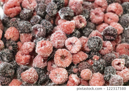 Healthy berry mix of frozen raspberries and blackberries. Frozen berries against background. Healthy berry mix of frozen raspberries and blackberries. Frozen berries against background. 122317380