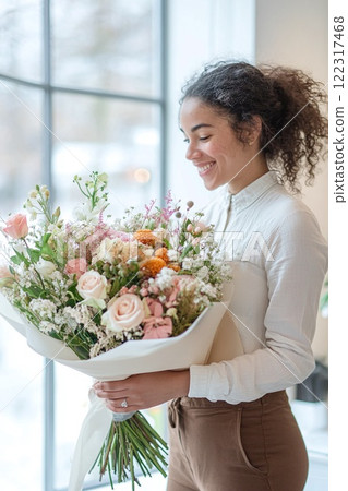 Smiling woman, florist holding a bouquet of flowers. 122317468