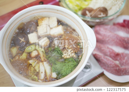 Family time: Smiling faces around sukiyaki at home Family time: Smiling faces around sukiyaki at home 122317575