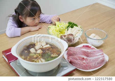 Family time: Smiling faces around sukiyaki at home Family time: Smiling faces around sukiyaki at home 122317580