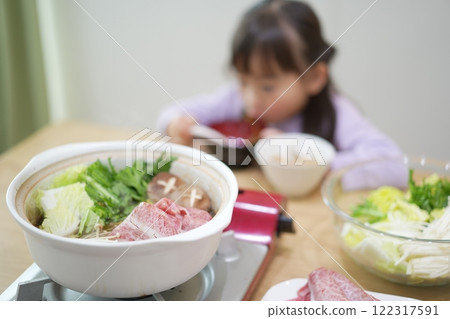 Family time: Smiling faces around sukiyaki at home Family time: Smiling faces around sukiyaki at home 122317591
