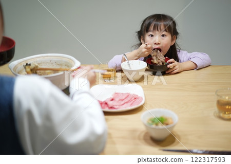 Family time: Smiling faces around sukiyaki at home Family time: Smiling faces around sukiyaki at home 122317593