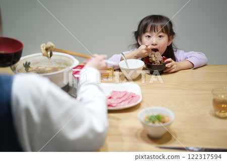 Family time: Smiling faces around sukiyaki at home Family time: Smiling faces around sukiyaki at home 122317594