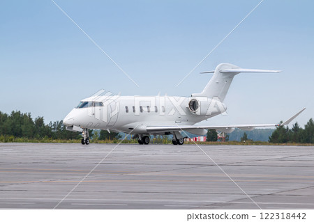 White luxury business jet taxiing on airport taxiway 122318442