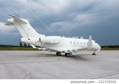 Modern white executive aircraft on the airport apron on a cloudy day 122318502