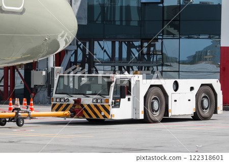 Tow truck pushes the passenger jet plane Tow truck pushes the passenger jet plane 122318601