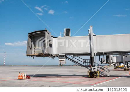 Empty passenger jet bridges at airport apron Empty passenger jet bridges at airport apron 122318603