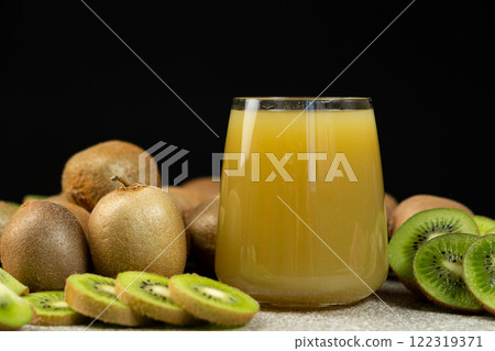 Kiwi juice in a glass among fresh kiwi fruits. 122319371