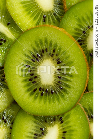 Vibrant Background of Freshly Sliced Kiwi Fruit Rings. A Lush and Refreshing Tropical Fruit Pattern with Juicy Green Tones 122319388