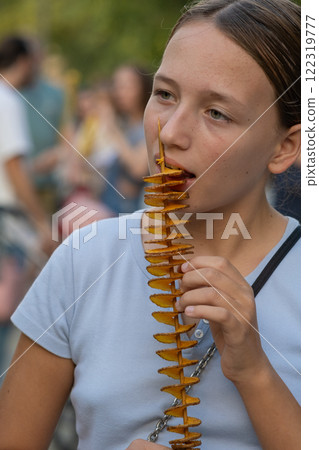 Girl Eating Potato Chips Spiral 122319777