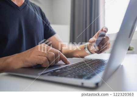 Man holding credit card while using laptop, shopping online, buying on internet. e-commerce e-banking service. 122320363