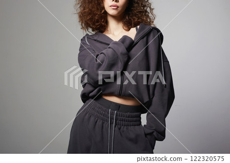 fashionable beautiful young woman in tracksuit of hoodie and trousers fashionable beautiful young woman in tracksuit of hoodie and trousers 122320575