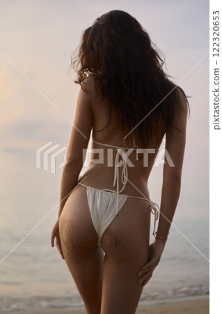 Beautiful body woman walking on the beach. Sexy back of girl in Bikini 122320653