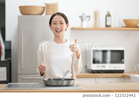 Middle aged woman cooking in the kitchen 122322442