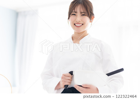 A smiling pastry chef holding pastry tools 122322464