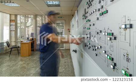 Factory Control Panel timelapse hyperlapse. Engineer standing in front of the control panel in the control room and pushing buttons and switches 122323158