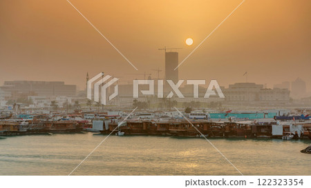 Sunset at Doha Bay timelapse with Traditional Wooden Dhow Fishing Boats. 122323354