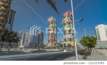 Doha skyline timelapse hyperlapse with colorful Al Marina Twin Towers building located the Lusail area of the capital of Qatar. 122323365