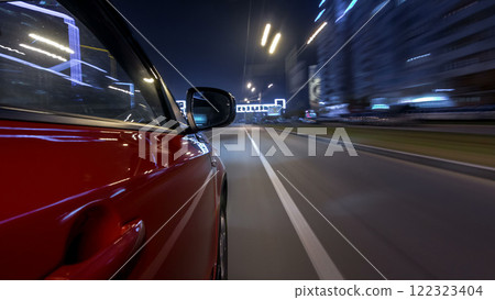 Drivelapse urban look from fast driving car at a night avenue in a city timelapse hyperlapse 122323404