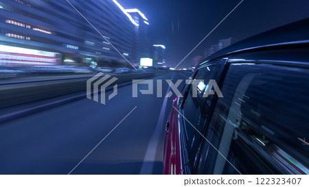 Drivelapse urban look from fast driving car at a night avenue in a city timelapse hyperlapse 122323407
