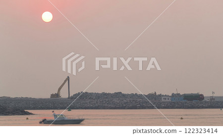 Relaxing Sunset in Dubai near beach. Calm sea and boat floating in Dubai timelapse Relaxing Sunset in Dubai near beach. Calm sea and boat floating in Dubai timelapse 122323414