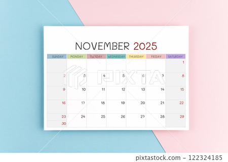 November 2025 calendar page on blue and pink background. 122324185